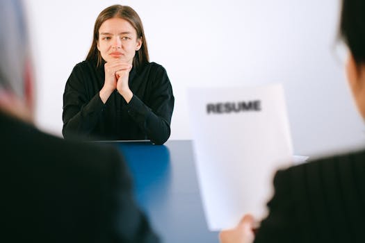 Woman in Black Long Sleeve Shirt Sitting Having Interview